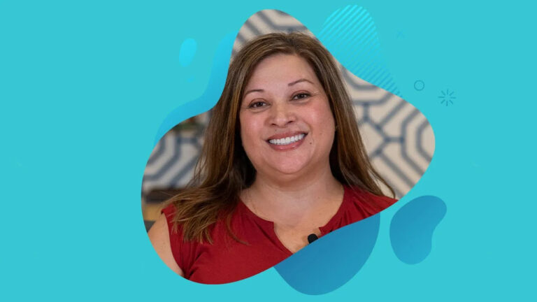 Portrait of a smiling person with long hair wearing a red shirt, set against a patterned blue background with abstract shapes. Their radiant expression captures the essence of life-changing beauty, reminiscent of the joy found at Miami Designer Smiles.
