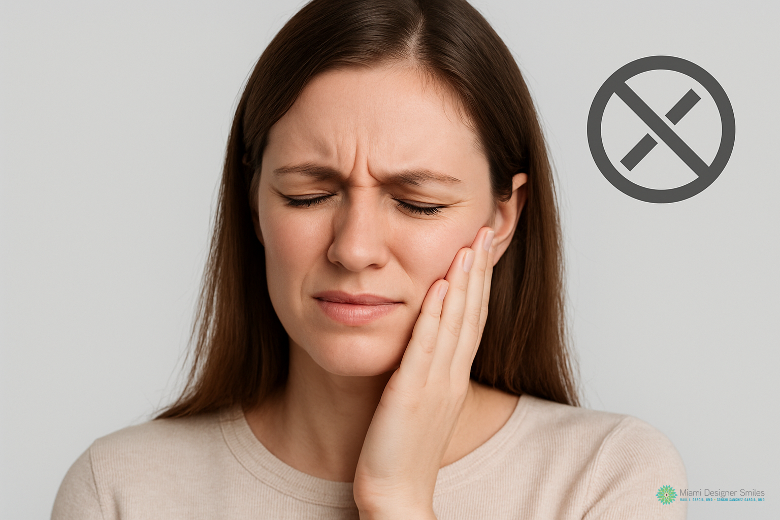 Woman holding her jaw in pain with a crossed-out symbol in the background, suggesting dental discomfort or a toothache and highlighting the need for TMJ treatment options.